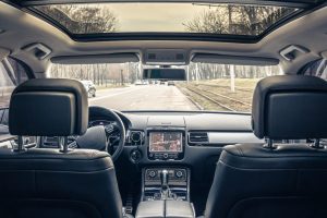 The interior of a modern car without people, a view from inside the car. The car is parked on a city street.